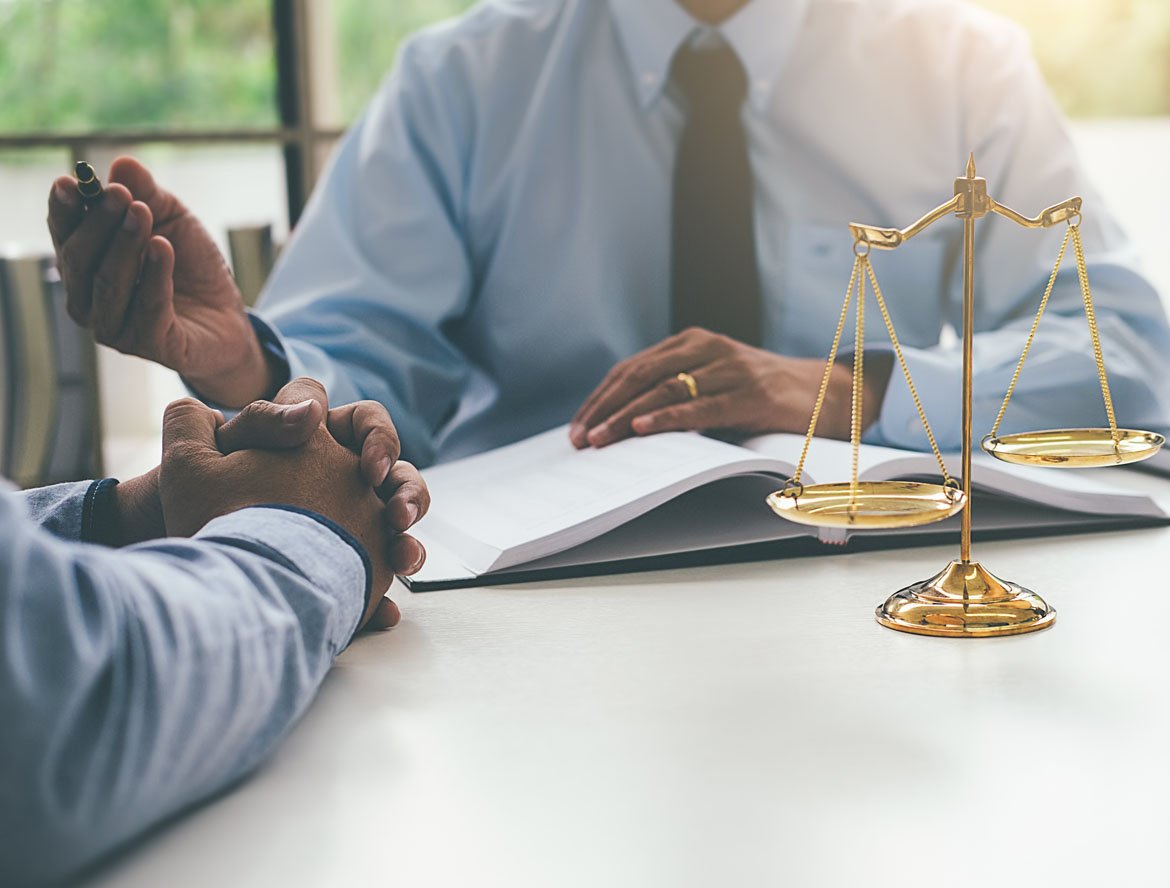 Legal professional reviewing documentation with a client